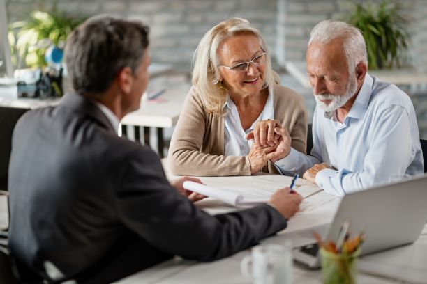 Senior couple reviewing retirement plans with a financial advisor